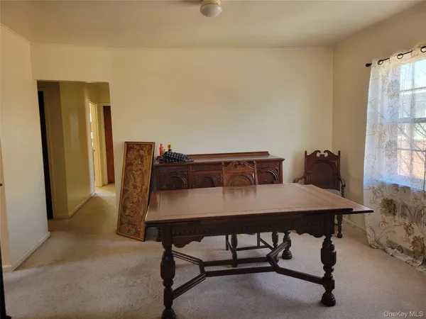 a view of a dining room with furniture and window