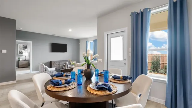 a dining room with furniture and window