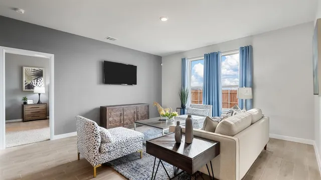 a living room with furniture and a potted plant