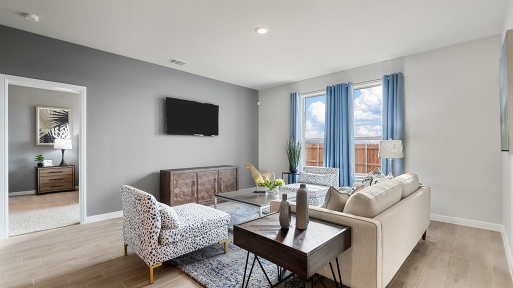 317 Potato Street Keene, TX 76059 - Photo 12 of 36 a living room with furniture and a flat screen tv