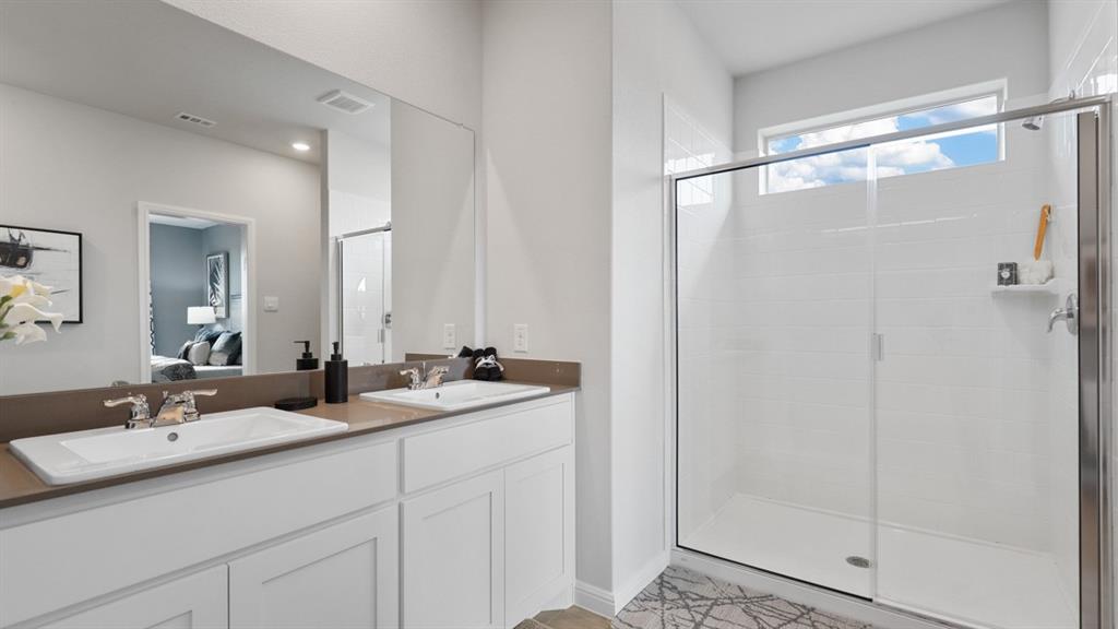 317 Potato Street Keene, TX 76059 - Photo 19 of 36 a bathroom with a double vanity sink and mirror