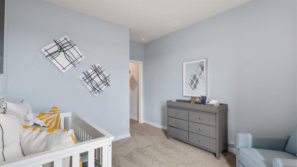 317 Potato Street Keene, TX 76059 - Photo 23 of 36 a bedroom with a bed and a chandelier