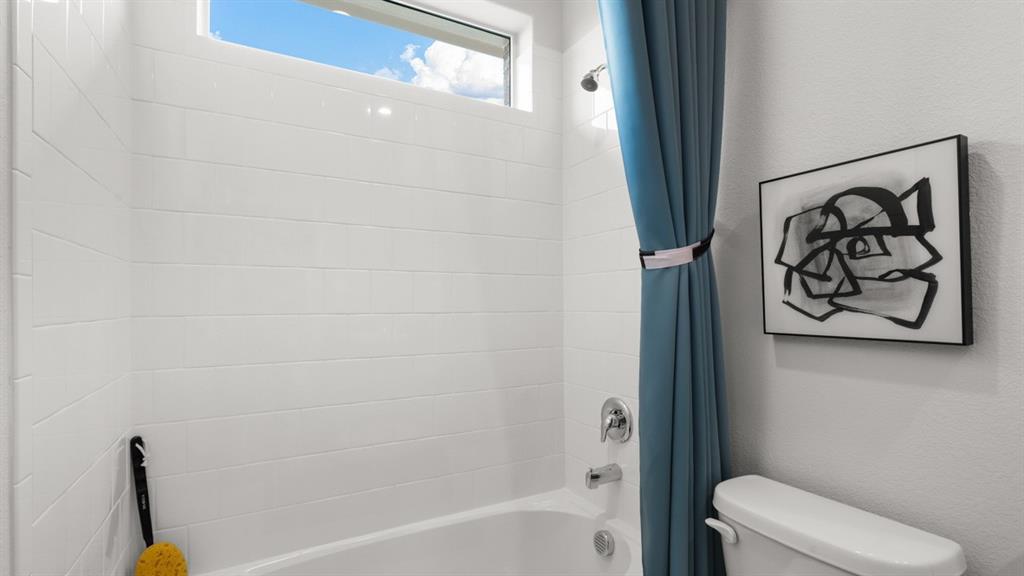 317 Potato Street Keene, TX 76059 - Photo 25 of 36 a bathroom with a bathtub and shower