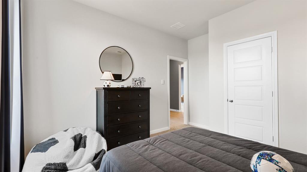 317 Potato Street Keene, TX 76059 - Photo 28 of 36 a bedroom with a bed and a dresser