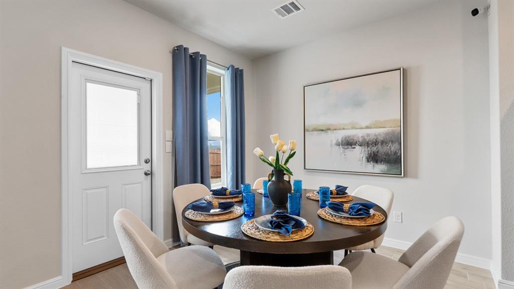 317 Potato Street Keene, TX 76059 - Photo 6 of 36 a view of a dining room with furniture a rug and wooden floor
