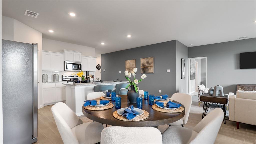 317 Potato Street Keene, TX 76059 - Photo 8 of 36 a kitchen with a dining table and chairs