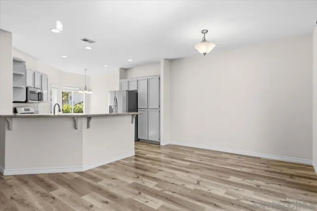 a view of a room with wooden floor and sliding glass door