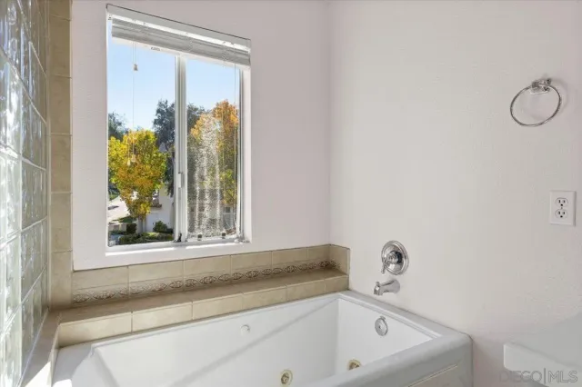 a bathroom with a granite countertop sink and a toilet