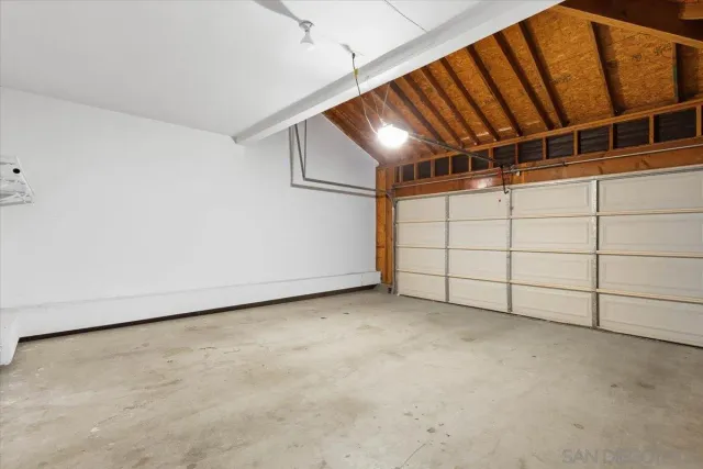 a view of a chairs and table in the back yard of the house