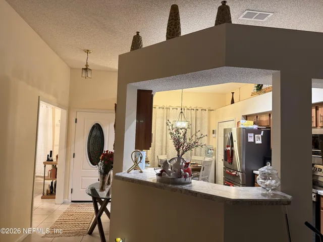 a bedroom with a bed and a lamp