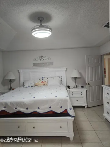 a living room with furniture a piano and a flat screen tv