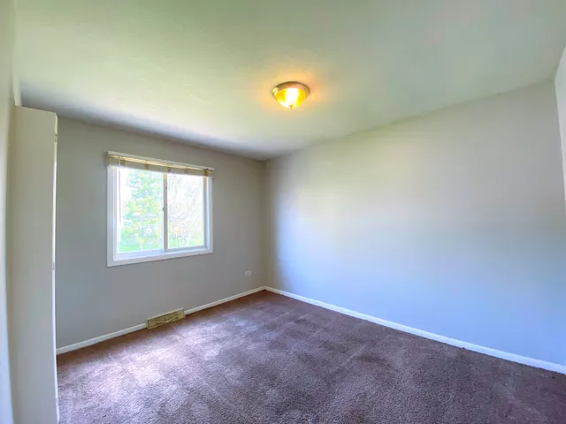 an empty room with a empty space and a window