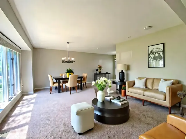 a living room with furniture and a chandelier