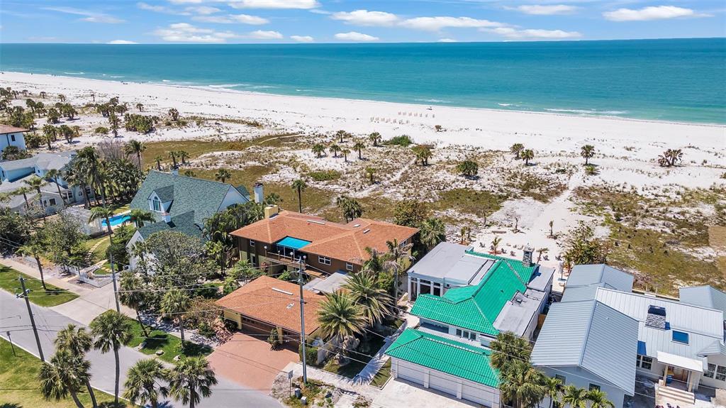 an aerial view of a houses with ocean view