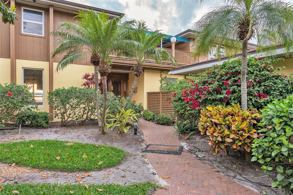 1058 Eldorado Avenue Clearwater Beach, FL 33767 - Photo 2 of 79 a view of a house with a garden
