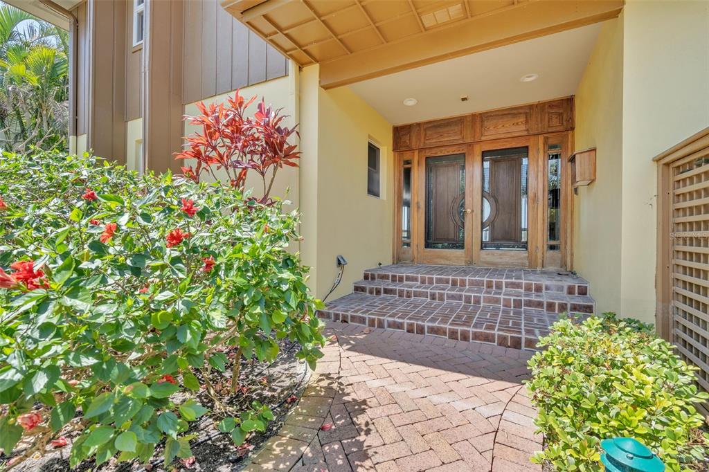 1058 Eldorado Avenue Clearwater Beach, FL 33767 - Photo 3 of 79 a view of a house with a flower garden