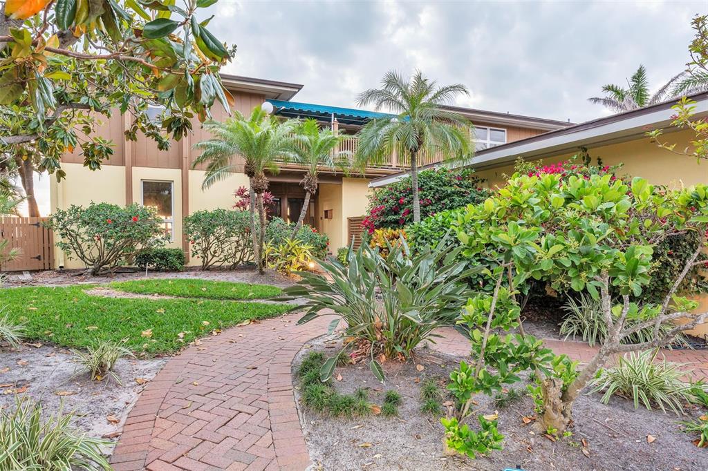1058 Eldorado Avenue Clearwater Beach, FL 33767 - Photo 65 of 79 a front view of a house with a yard and potted plants