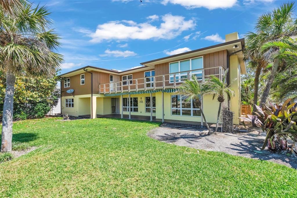 1058 Eldorado Avenue Clearwater Beach, FL 33767 - Photo 7 of 79 a view of a house with a yard