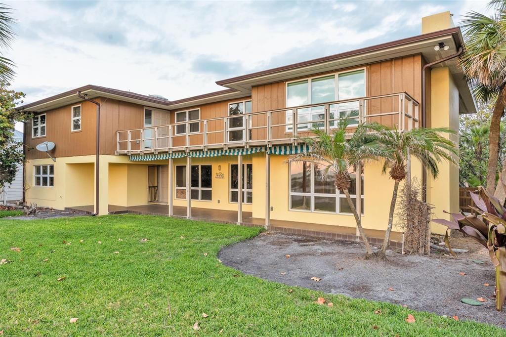1058 Eldorado Avenue Clearwater Beach, FL 33767 - Photo 72 of 79 a front view of a house with a yard and potted plants