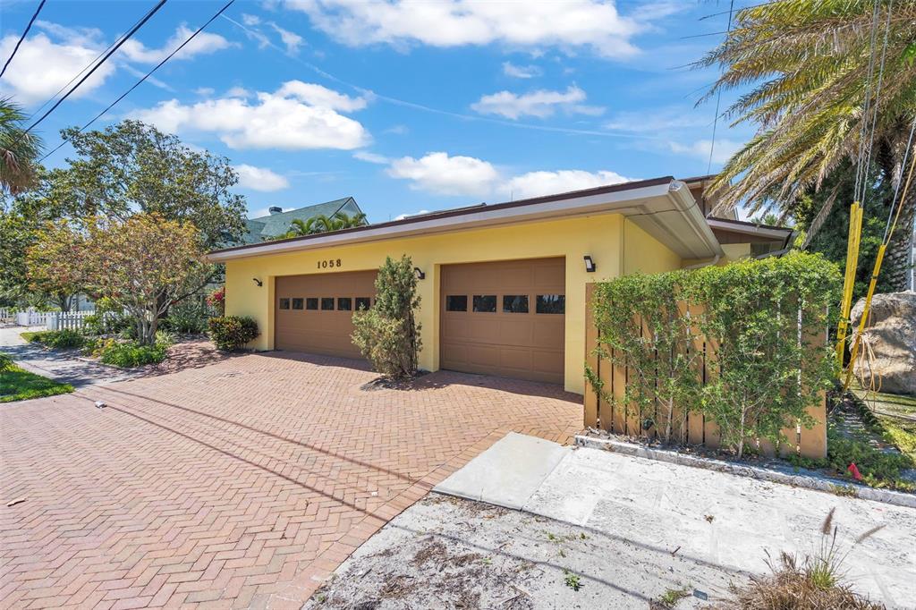1058 Eldorado Avenue Clearwater Beach, FL 33767 - Photo 10 of 79 a front view of a house with a yard