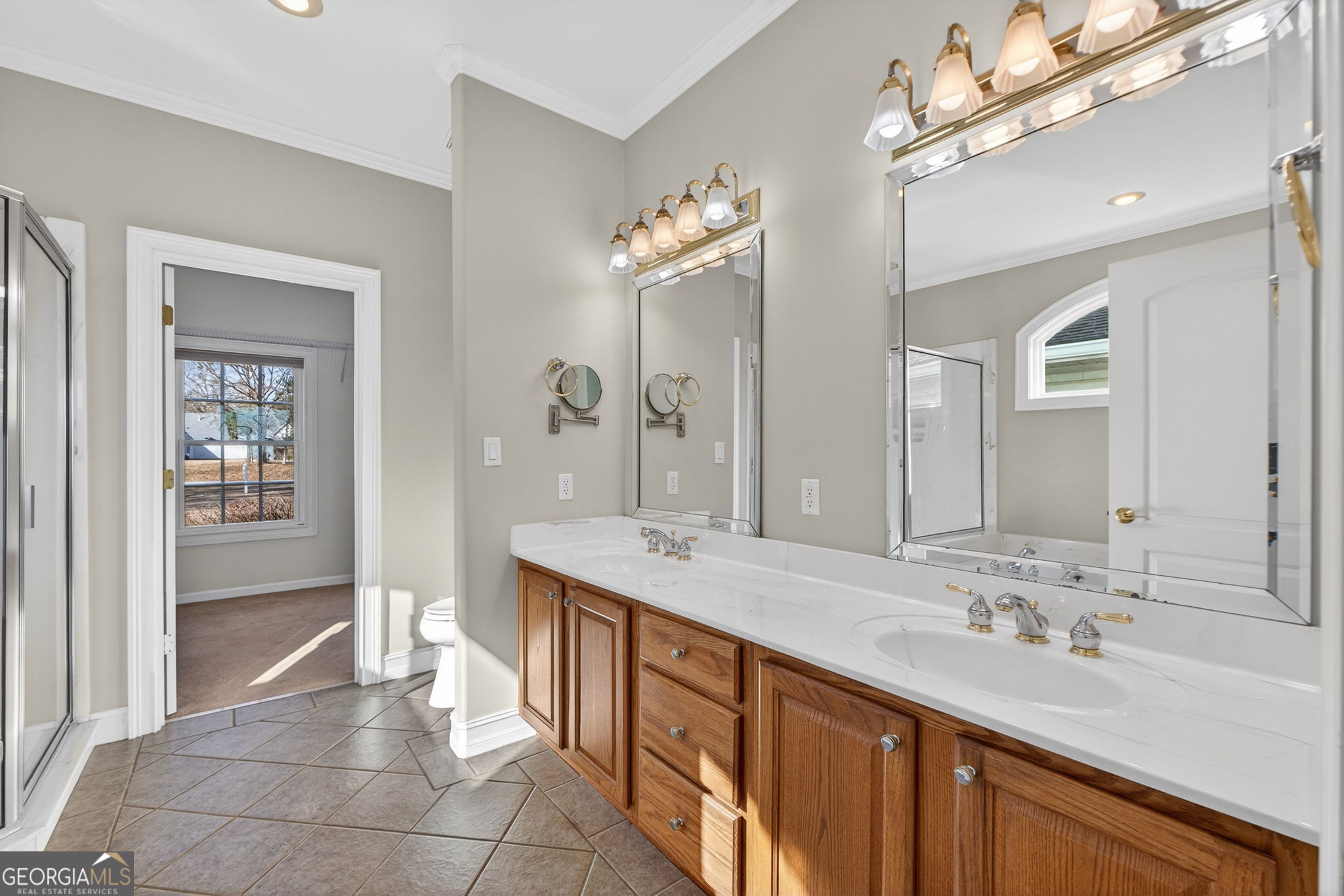 357 Canvasback Trail Locust Grove, GA 30248 - Photo 17 of 35 a spacious bathroom with a double vanity sink a mirror and a shower