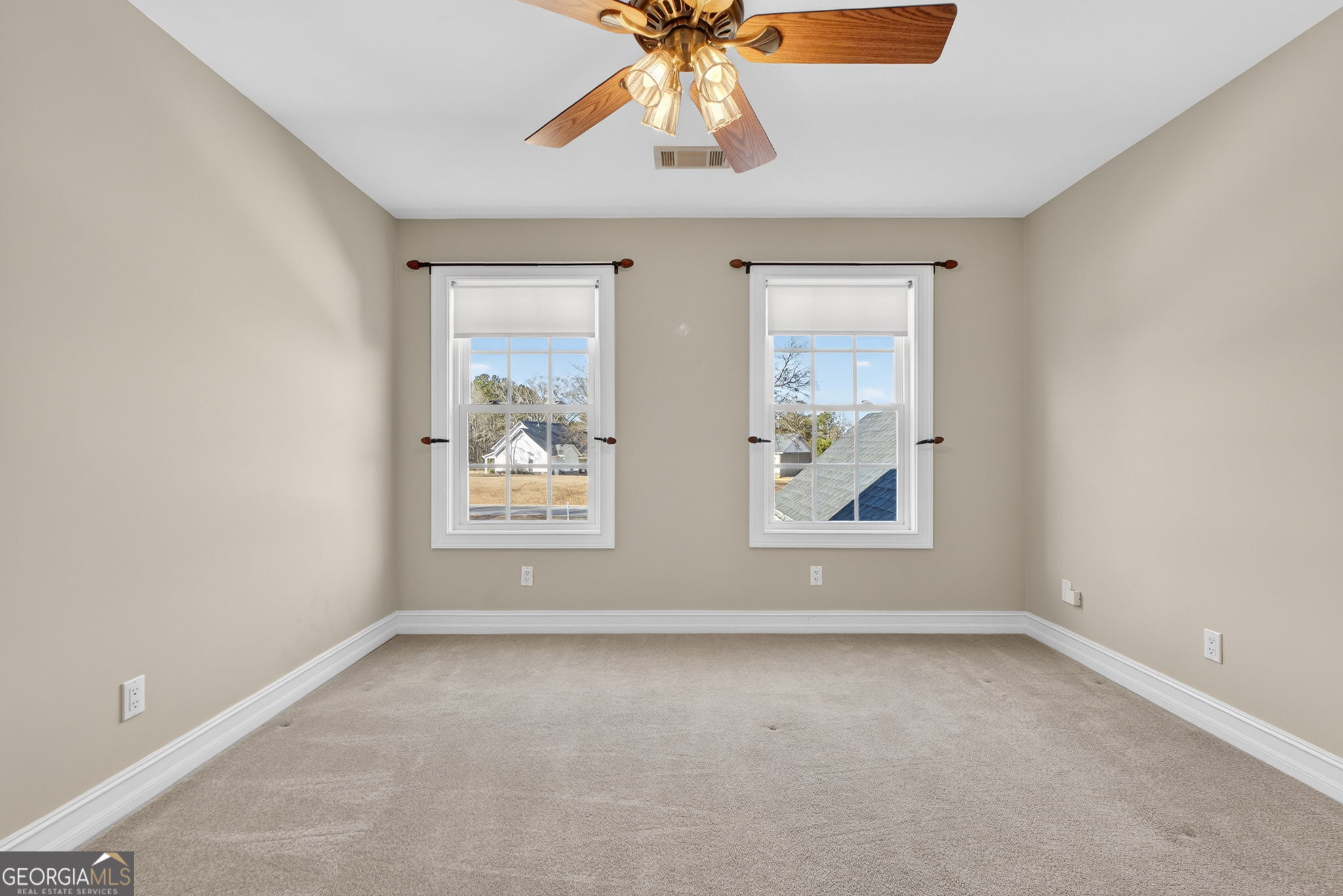 357 Canvasback Trail Locust Grove, GA 30248 - Photo 22 of 35 an empty room with windows and chandelier fan