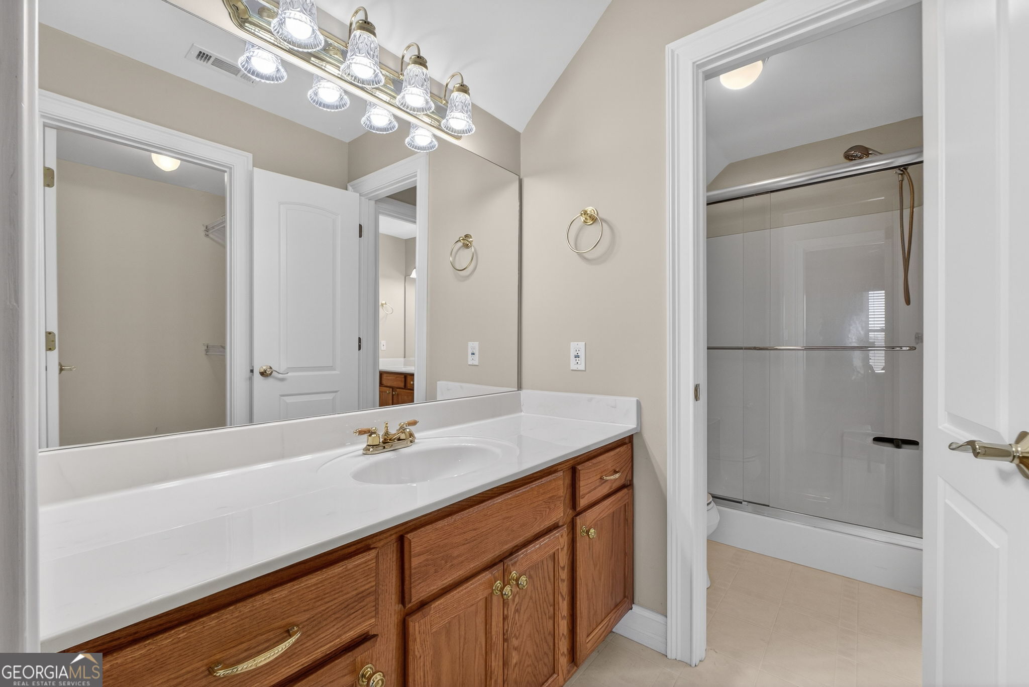 357 Canvasback Trail Locust Grove, GA 30248 - Photo 26 of 35 a bathroom with a sink shower and a mirror