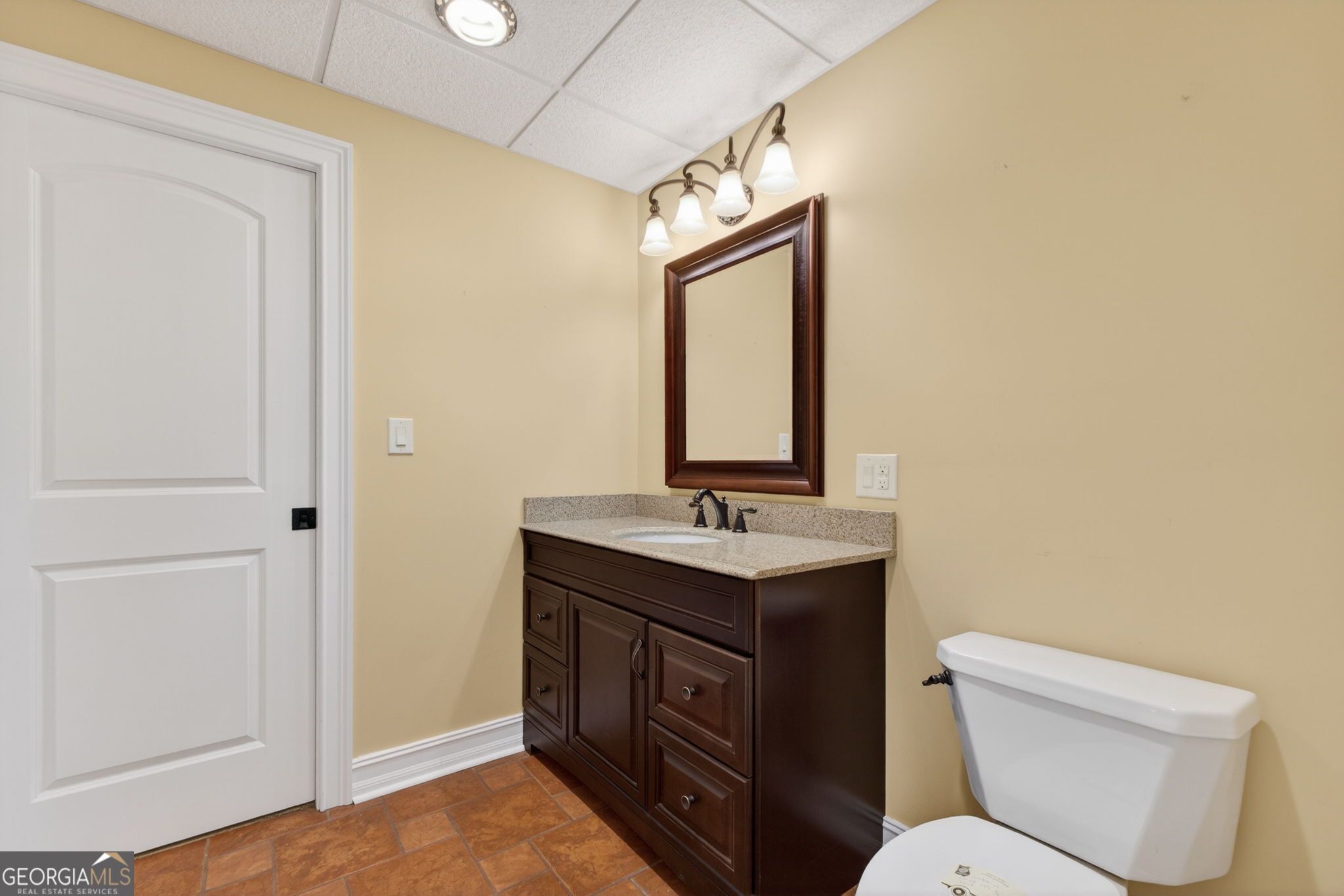 357 Canvasback Trail Locust Grove, GA 30248 - Photo 28 of 35 a bathroom with a toilet sink and mirror