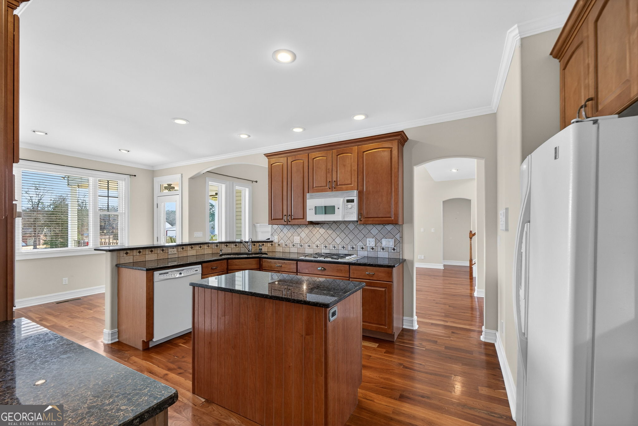 357 Canvasback Trail Locust Grove, GA 30248 - Photo 7 of 35 a kitchen with stainless steel appliances granite countertop a sink and a refrigerator