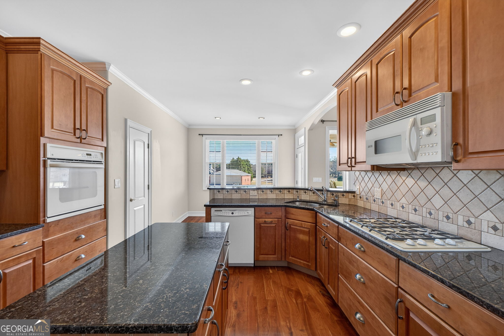 357 Canvasback Trail Locust Grove, GA 30248 - Photo 8 of 35 a kitchen with stainless steel appliances granite countertop a sink stove and refrigerator