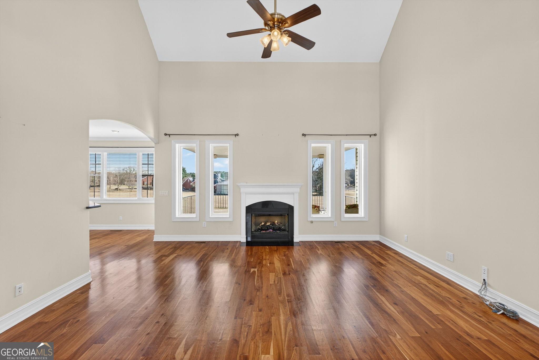 357 Canvasback Trail Locust Grove, GA 30248 - Photo 9 of 35 a view of a livingroom with wooden floor and a fireplace