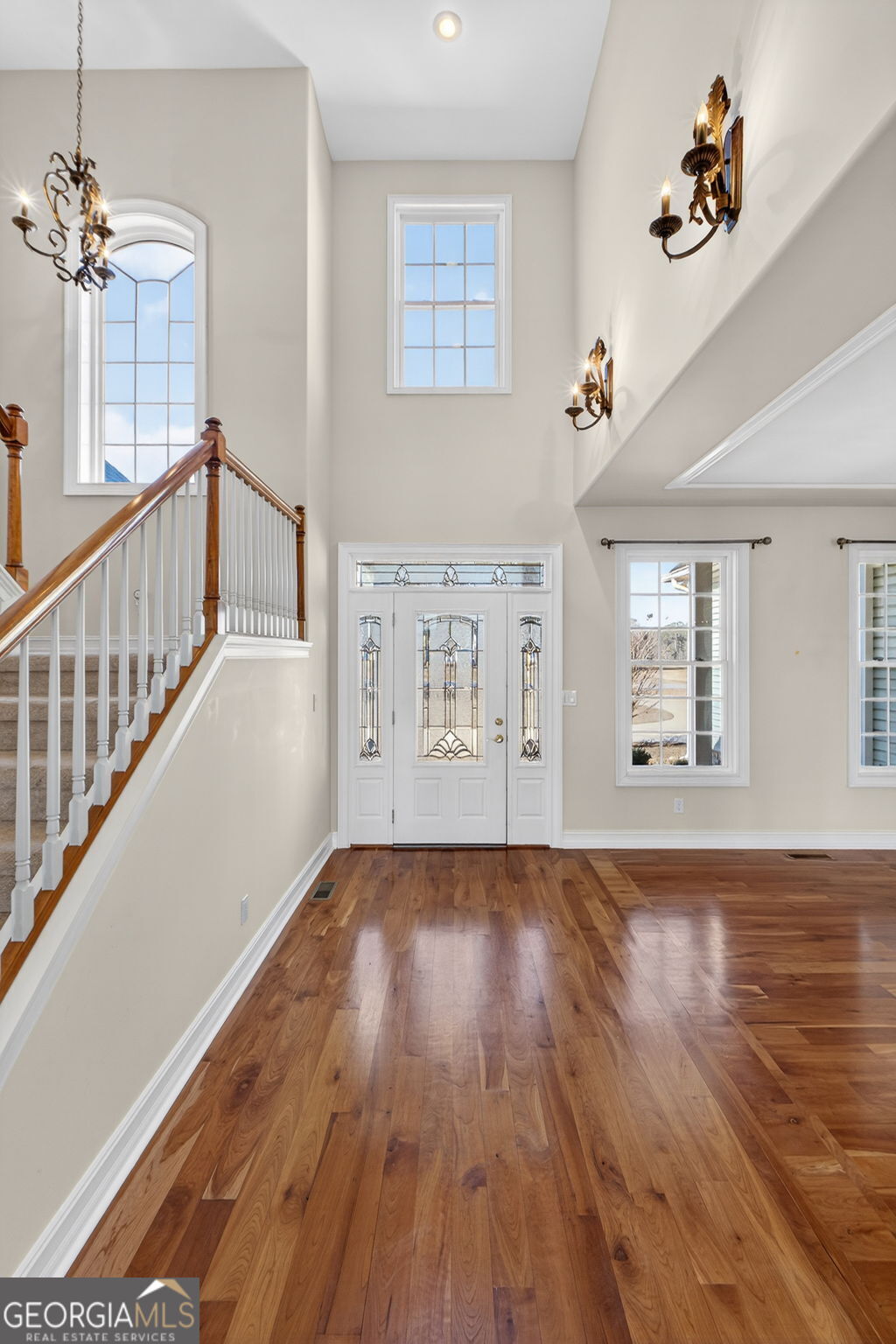 357 Canvasback Trail Locust Grove, GA 30248 - Photo 10 of 35 a view of an empty room with wooden floor and windows