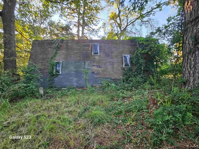 a view of a brick house with a yard