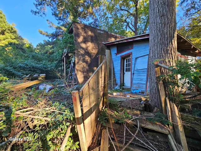 a yellow house with trees in front of it