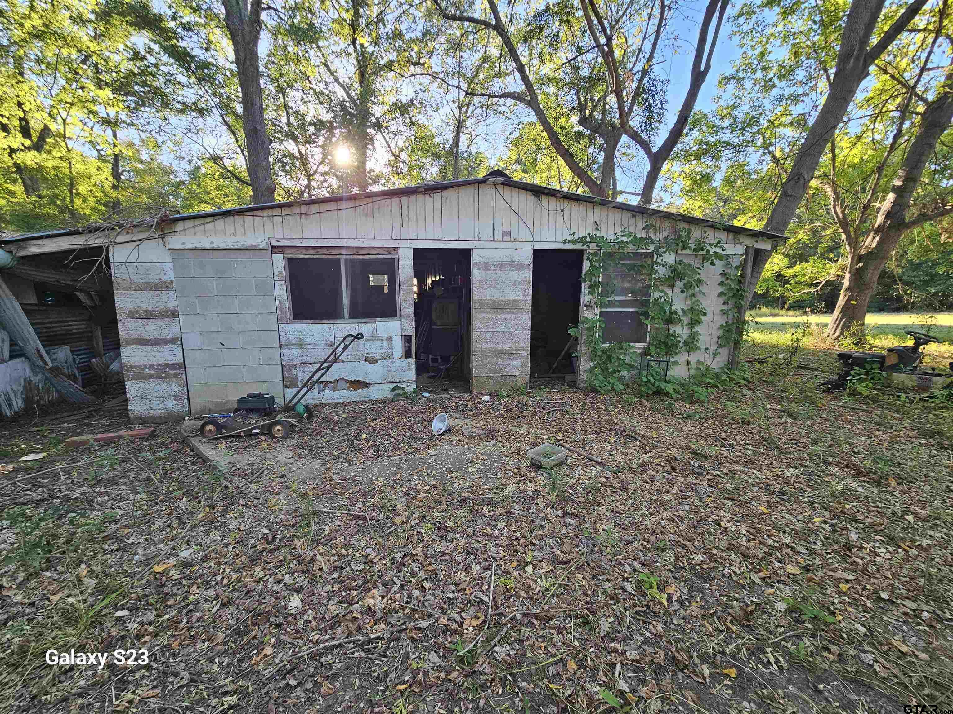 15830 Shady Creek Road Tyler, TX 75705 - Photo 24 of 32 a view of a house with a yard and large tree