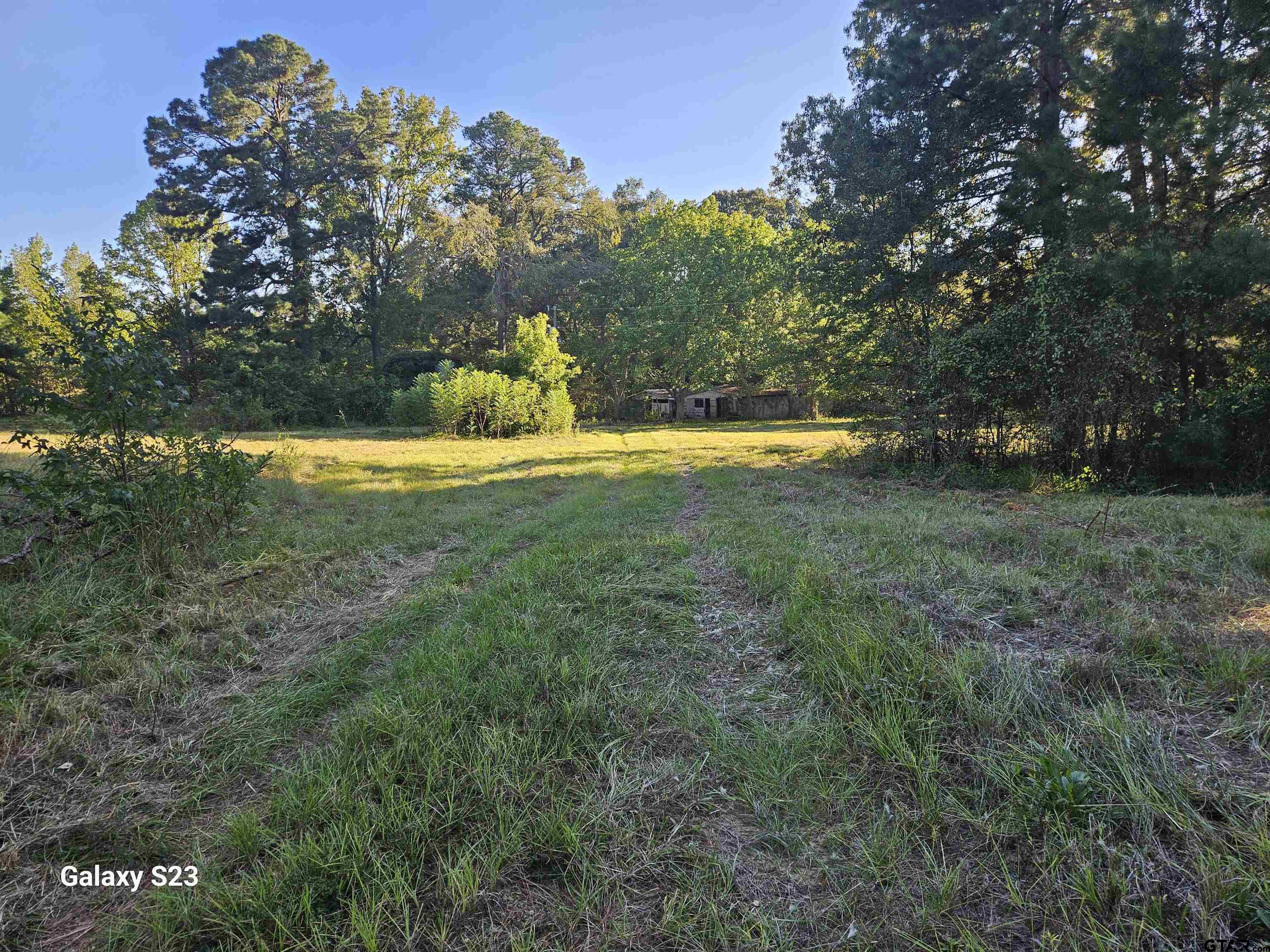 15830 Shady Creek Road Tyler, TX 75705 - Photo 30 of 32 a view of a swimming pool with an outdoor space and seating area