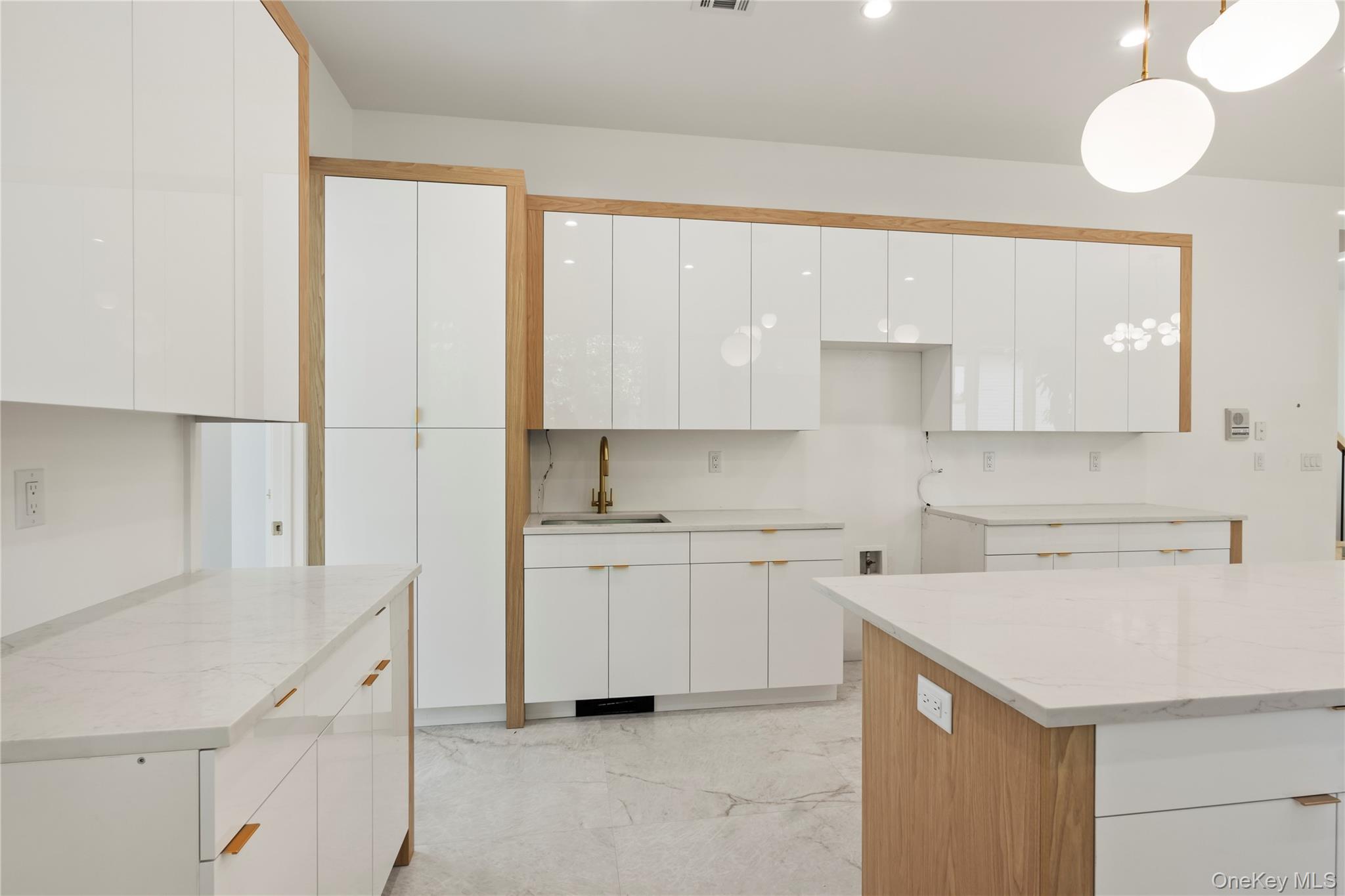 128 Union Road, Unit 201 Spring Valley, NY 10977 - Photo 13 of 48 Kitchen featuring white cabinets, light stone countertops, light marble finish flooring, and hanging light fixtures