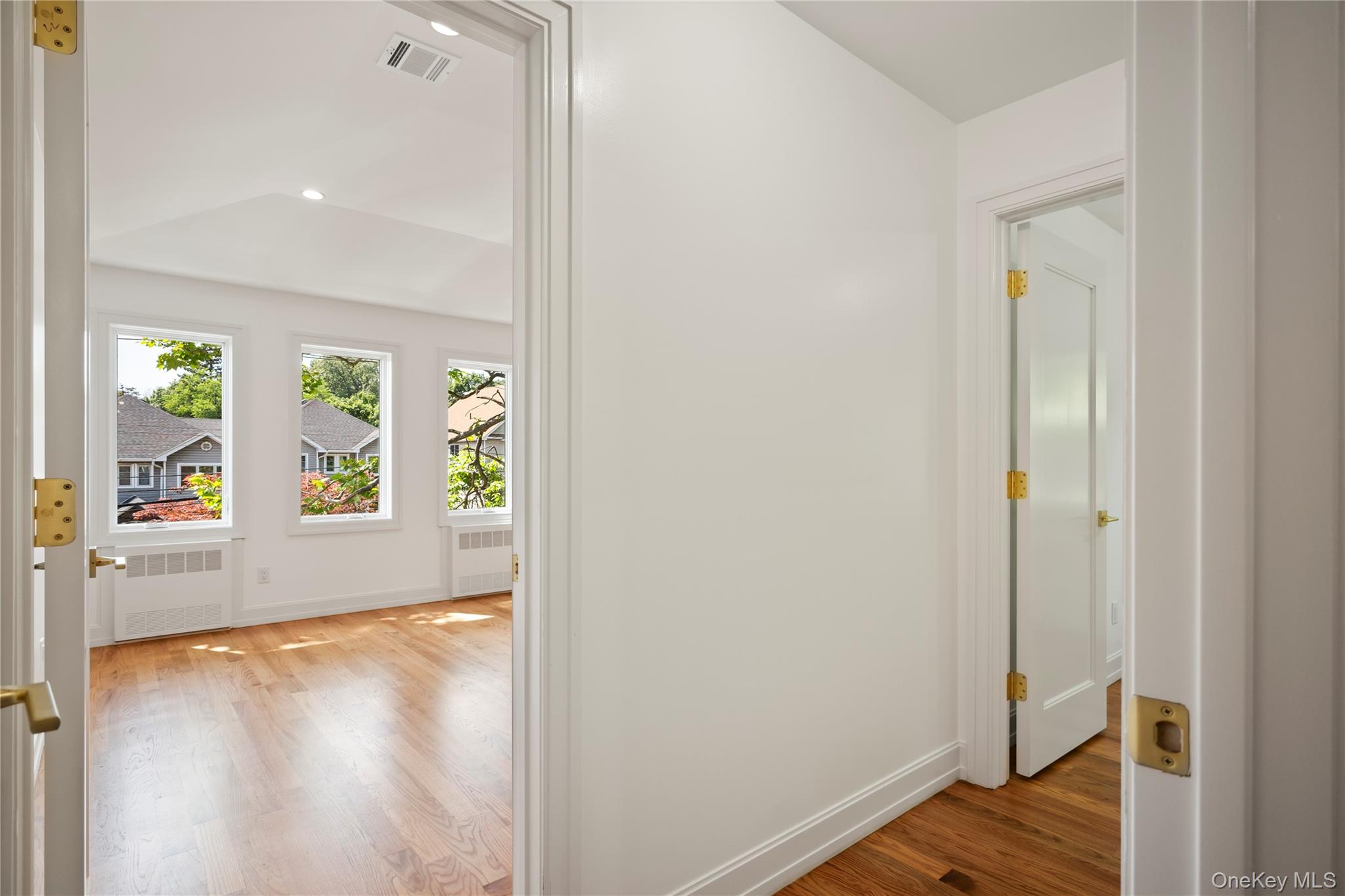 128 Union Road, Unit 201 Spring Valley, NY 10977 - Photo 23 of 48 Hallway with light wood-style flooring, radiator, and recessed lighting