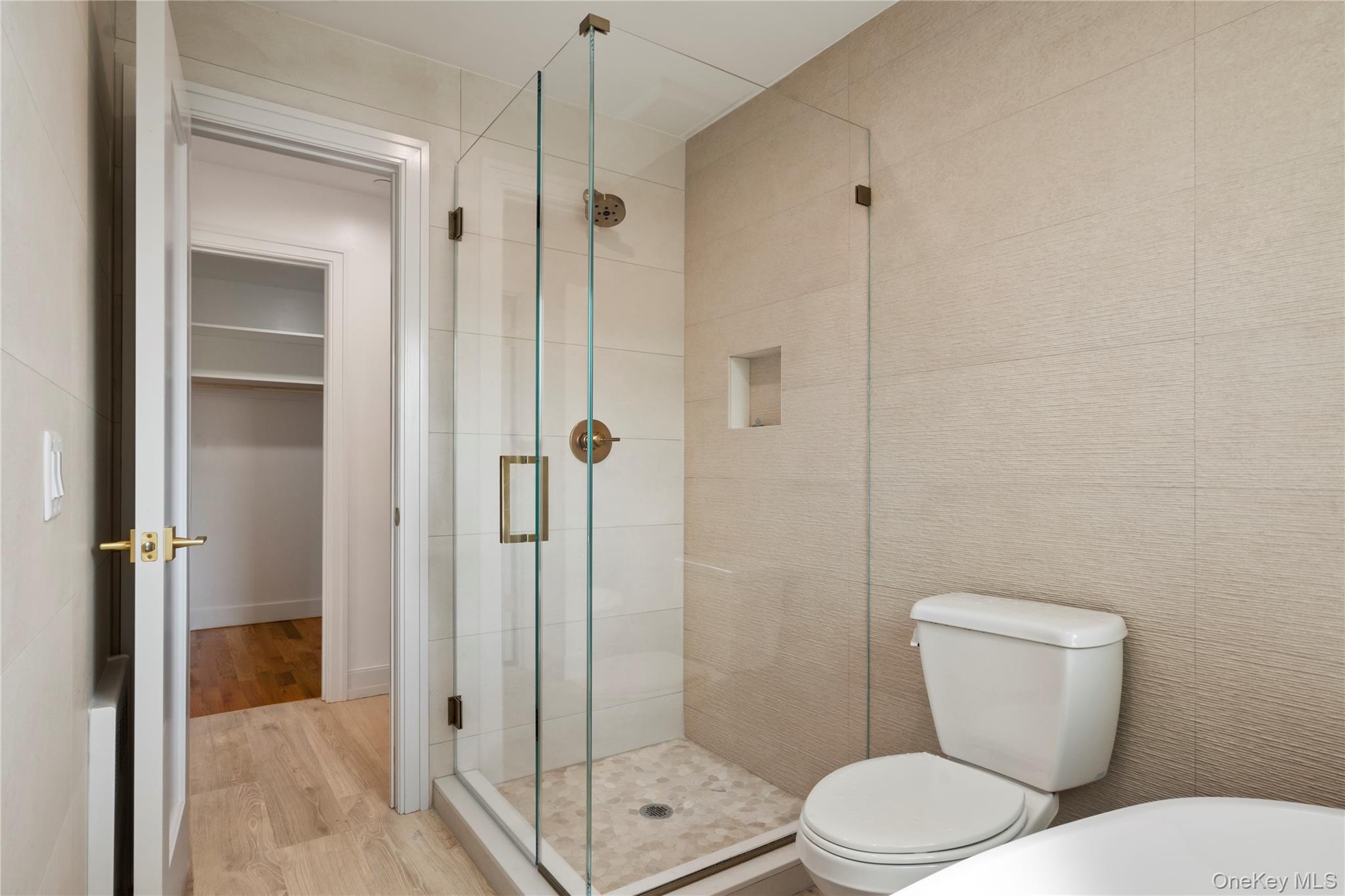 128 Union Road, Unit 201 Spring Valley, NY 10977 - Photo 29 of 48 Full bathroom with wood finished floors, a stall shower, and a spacious closet