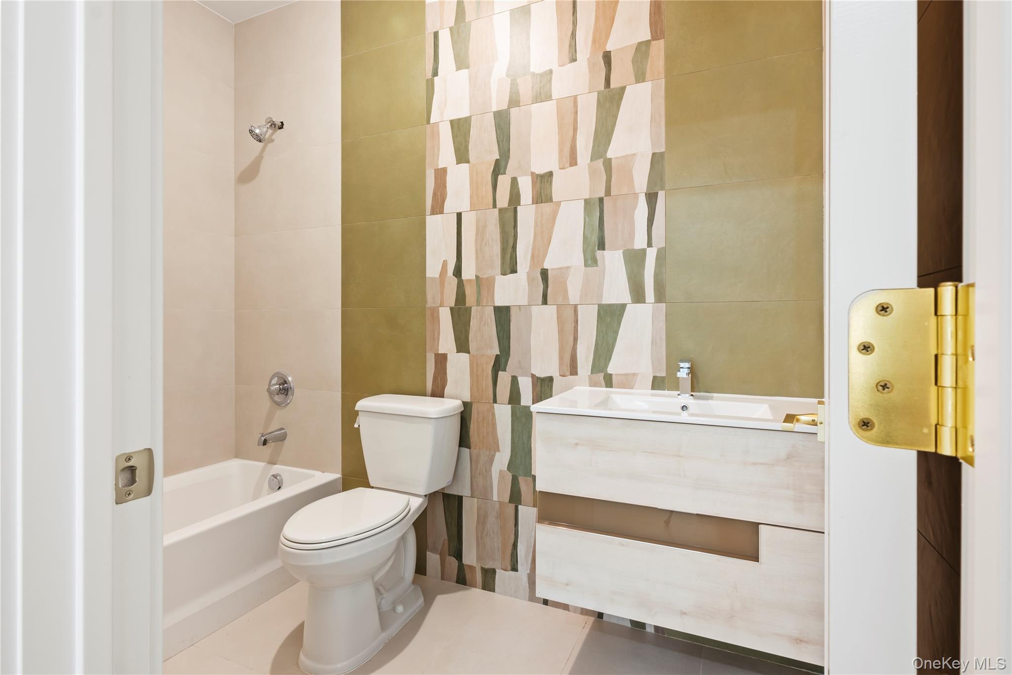 128 Union Road, Unit 201 Spring Valley, NY 10977 - Photo 43 of 48 Bathroom featuring bathtub / shower combination, vanity, and tile walls