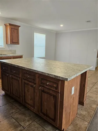 a kitchen with stainless steel appliances granite countertop a sink and wooden cabinets