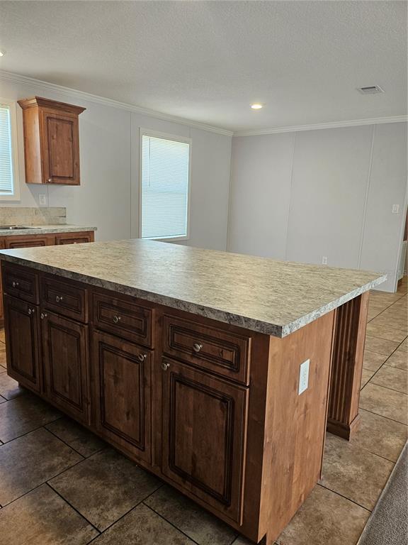 5636 West O Griffin Road Plant City, FL 33567 - Photo 12 of 20 a kitchen with stainless steel appliances granite countertop a sink and wooden cabinets