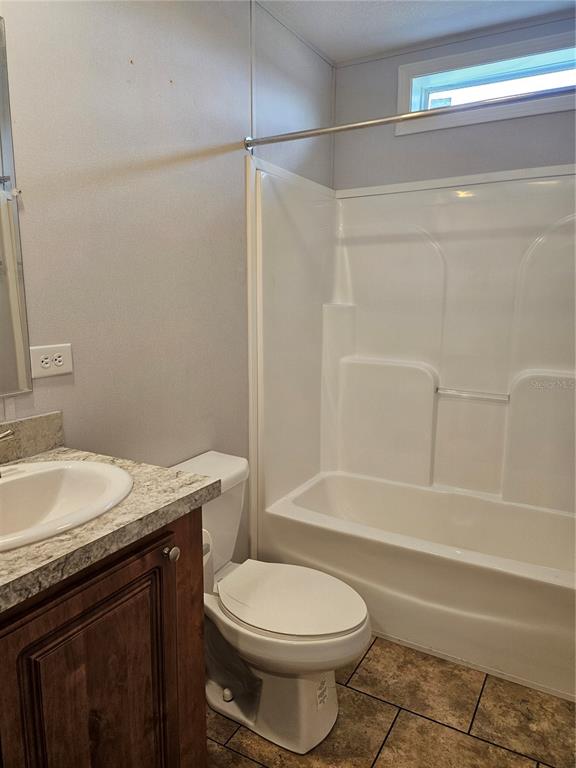 5636 West O Griffin Road Plant City, FL 33567 - Photo 15 of 20 a bathroom with a granite countertop bathtub shower sink vanity and toilet