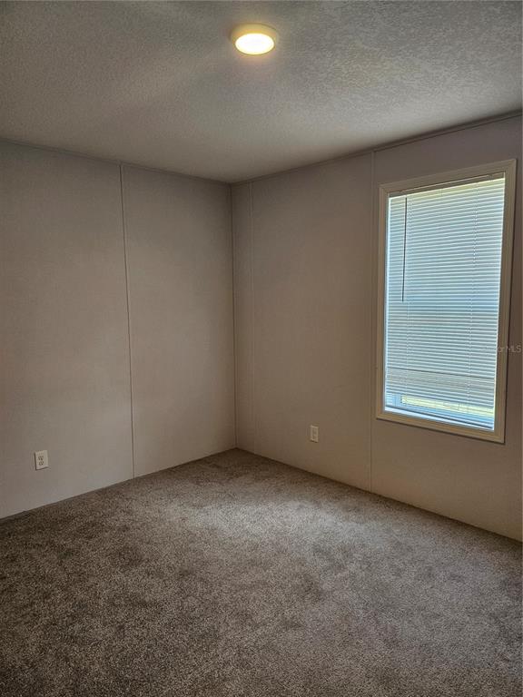 5636 West O Griffin Road Plant City, FL 33567 - Photo 16 of 20 an empty room with a window