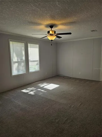 an empty room with a empty space and windows