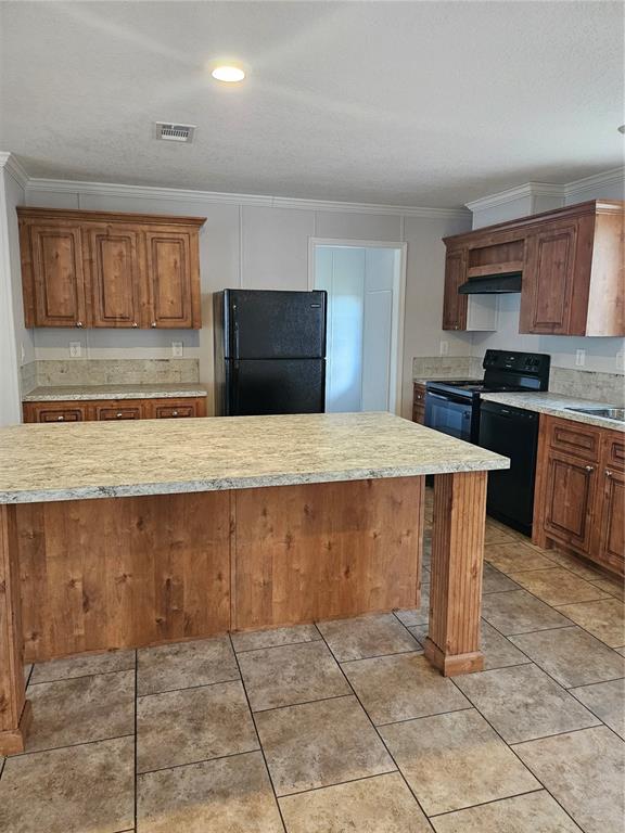 5636 West O Griffin Road Plant City, FL 33567 - Photo 4 of 20 a kitchen with kitchen island granite countertop a stove a sink and a microwave
