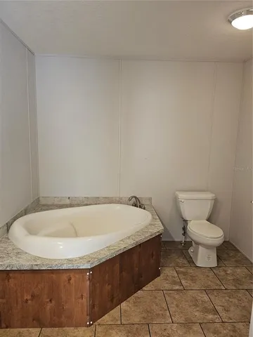 a bathroom with a toilet and a bathtub
