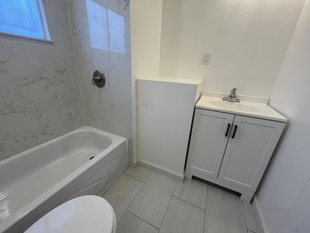 4143 Yosemite Boulevard Modesto, CA 95357 - Photo 15 of 22 a bathroom with a sink a toilet and bathtub