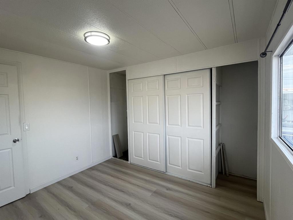 4143 Yosemite Boulevard Modesto, CA 95357 - Photo 18 of 22 an empty room with wooden floor and closet area