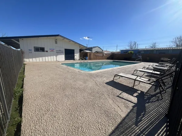 a roof deck with furniture and a flat screen tv